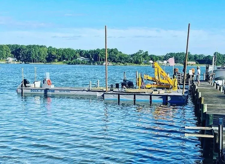 The barge with its crane alongside a pier after a repair