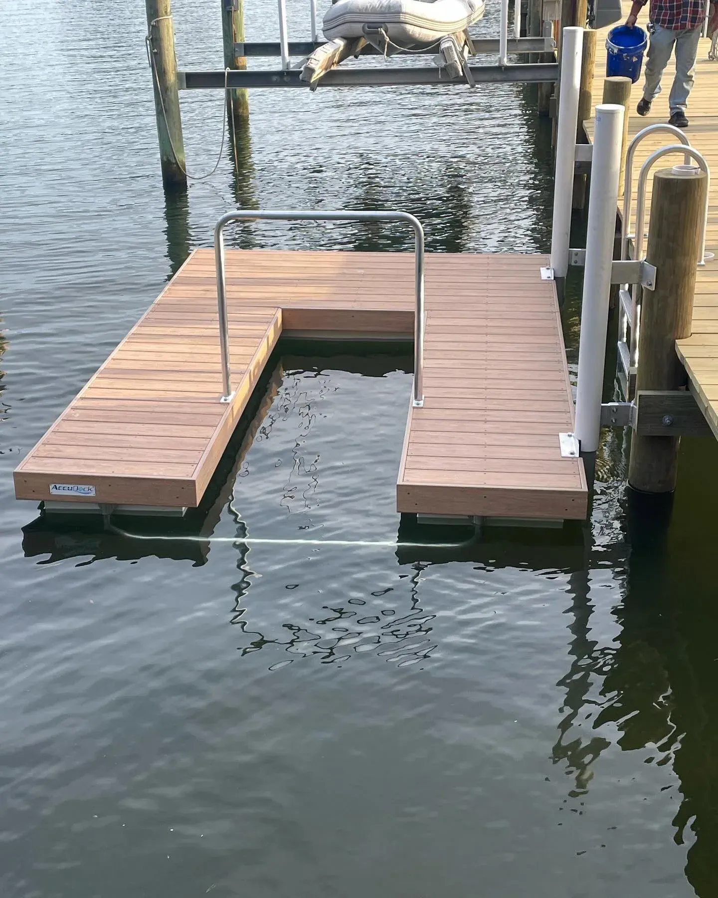 Looking down on a floating paddle board launch with rails beside a dock