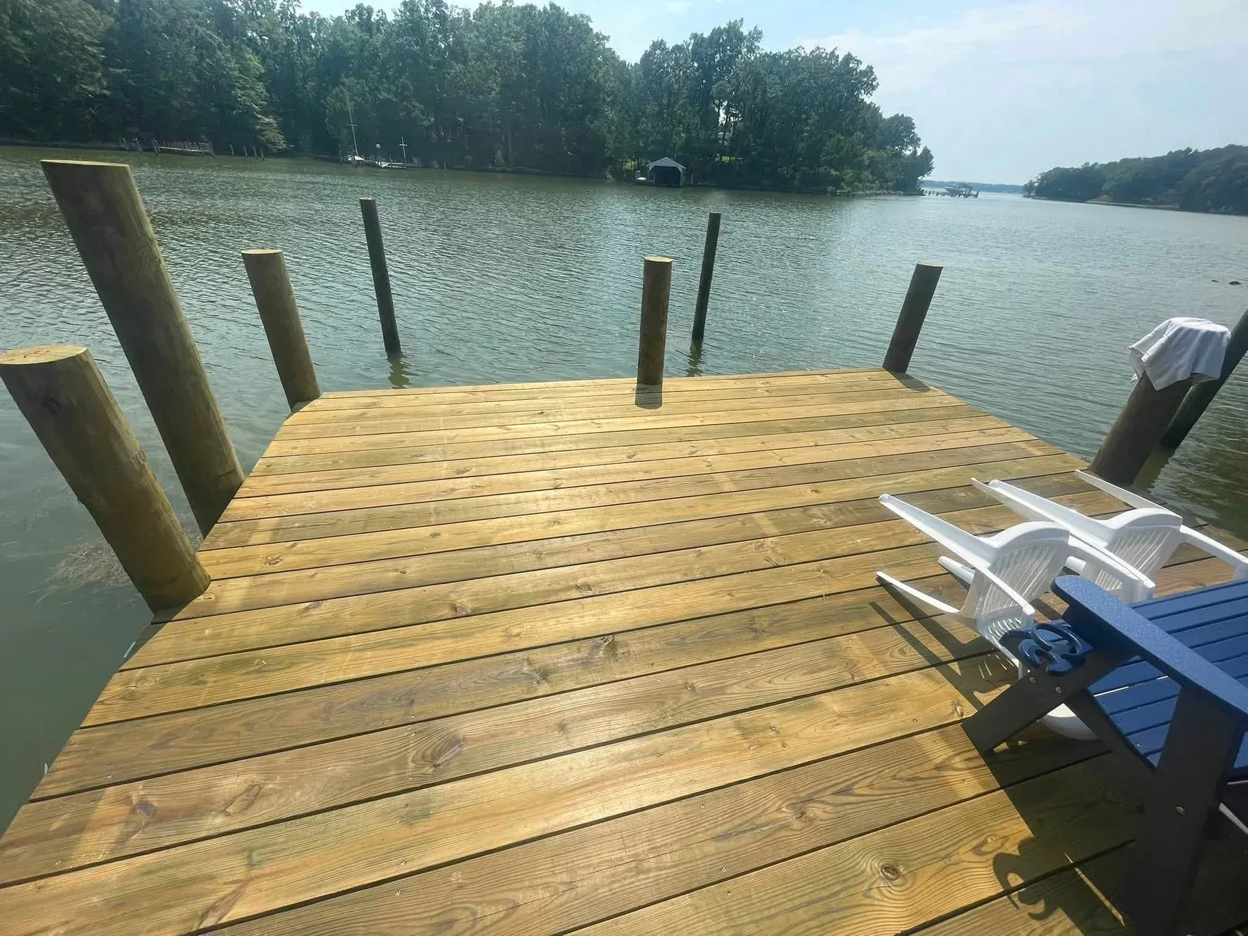 A new pier head platform with tall pilings on a creek