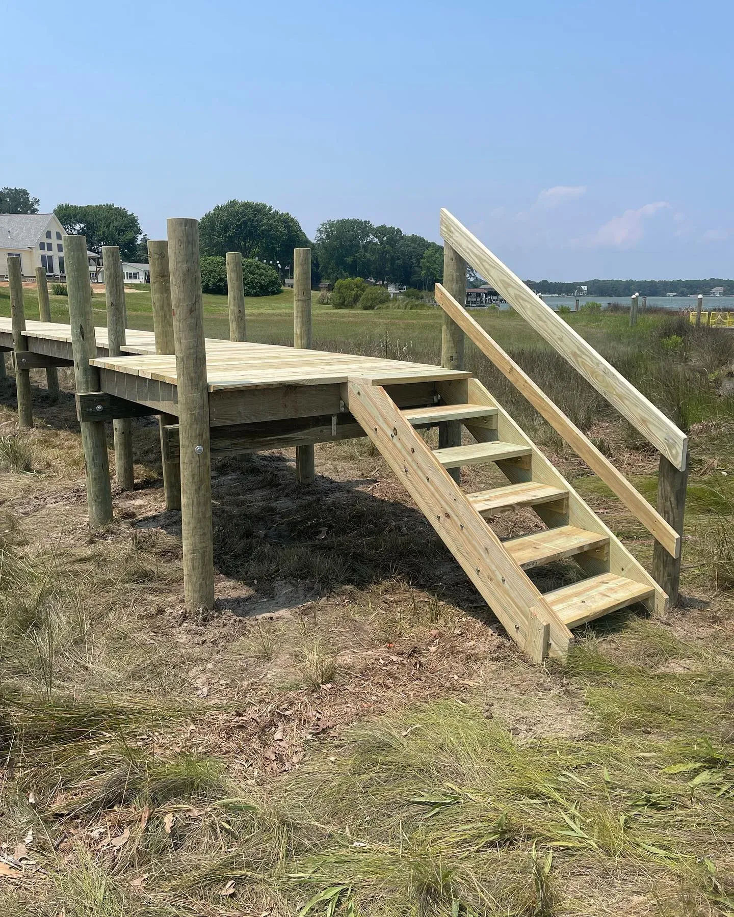 A new pier platform with stairs down through the marsh grass