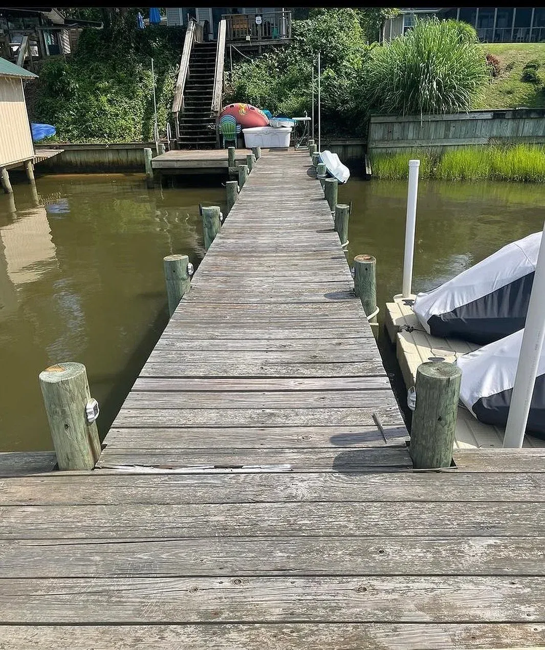 A weathered gray pier deck before replacement